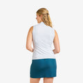 A woman shown from the back wearing a sleeveless white athletic top and a teal mini skirt against a plain light gray studio background.