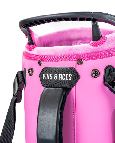 Close-up of the Player Preferred Golf Bag in Bubblegum 2.0, featuring a vibrant pink exterior and branded handle.
