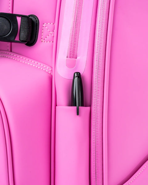 Bright pink Player Preferred Golf Bag featuring a sleek design with a pen holder and durable zippers for golfers.